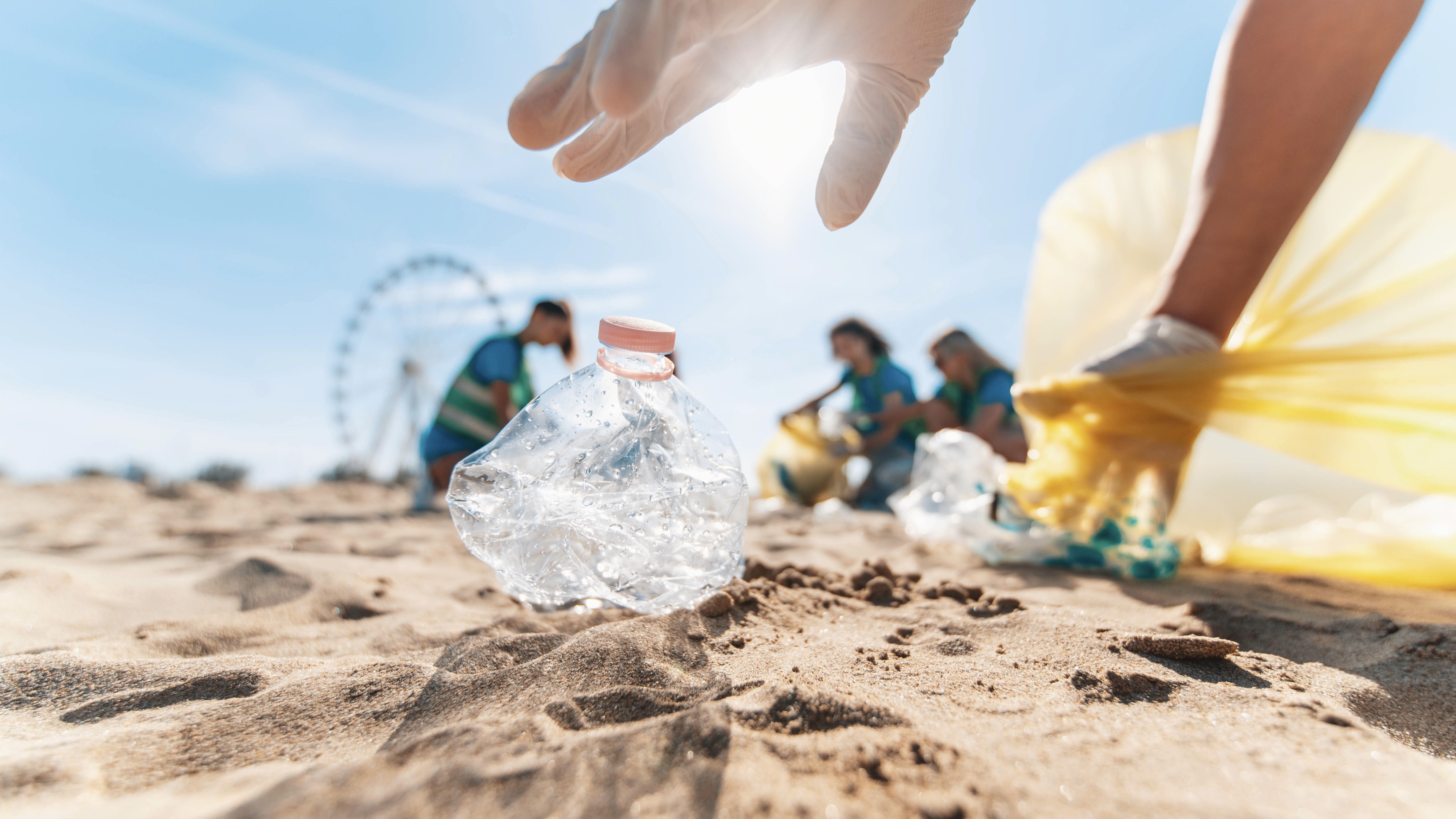 People cleaning beach from plastic waste